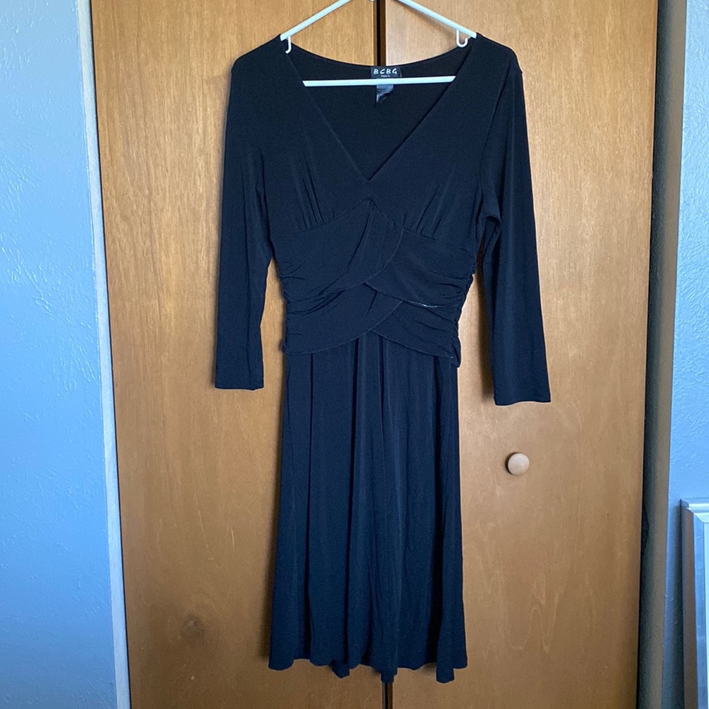 Black BCBG dress with layered waist detail and 3/4 length sleeves hits at knee.
